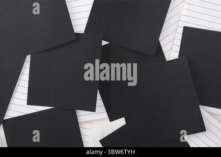 Black paper strewn over notepad Stock Photo
