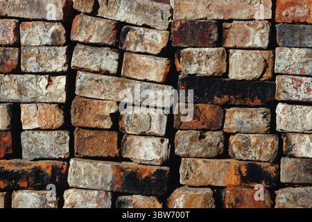 Folded old red brick background. The old building material is stacked. Abstract texture background Stock Photo