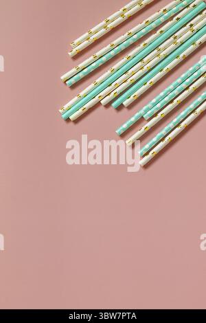 Biodegradable drinking straws for party isolated on pink background. Top view flat lay background. Copy space Stock Photo