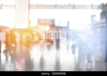 Blurry background of crowd people in airport. Business and Lifestyle concept. Blue and orange tone. Warm and Cool gradient light elements. For Report Stock Photo