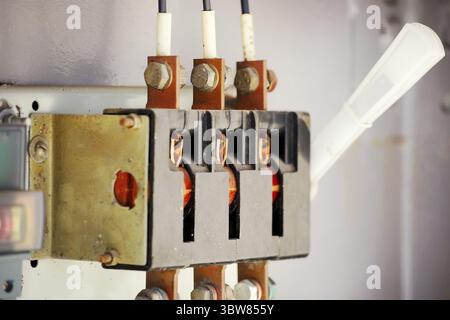 The old manual switch of disconnecting the voltage in the transformer box close-up. Manual switching device Stock Photo