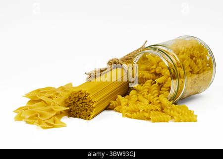 Various types of raw pasta in different containers in an isolated shot, with copy space on a white background Stock Photo