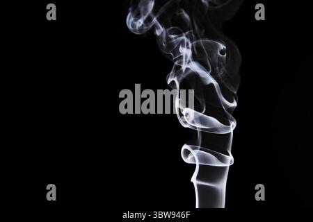Abstract figure created by white smoke on an isolated black background to stimulate the subconscious with truly beautiful shapes Stock Photo