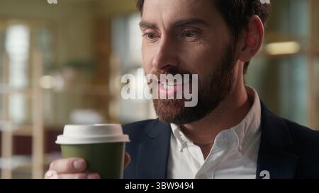 Caucasian business man guy drink coffee in office morning delicious beverage foretaste businessman enjoying aroma smell drinking hot cup tea male Stock Photo