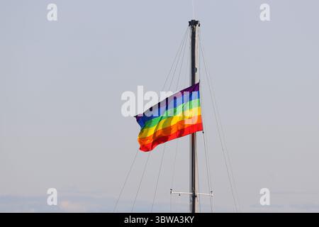 Rainbow pride flag hanging on boat mast Stock Photo