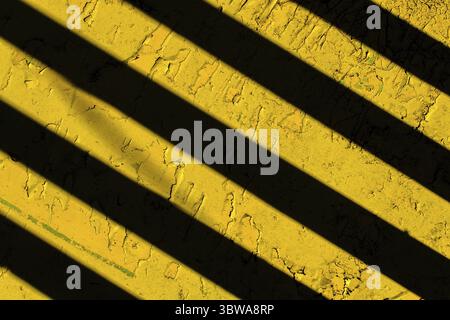 Yellow background with black diagonal stripes. Abstract background for the design Stock Photo