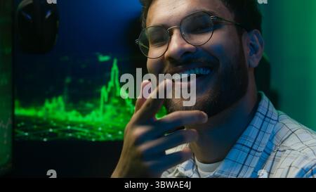 Thoughtful pensive Arabian Indian man thinking pondering solution programmer coder hacker worker cyberspace analysis male guy puzzled trader broker Stock Photo
