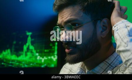 Close up face nervous Arabian Indian man looking computer monitor data problem trouble male guy businessman error loss business indoor stressed Stock Photo