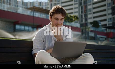 Happy Caucasian man working remote laptop computer entrepreneur smiling male guy freelancer businessman online social networks outdoor office internet Stock Photo