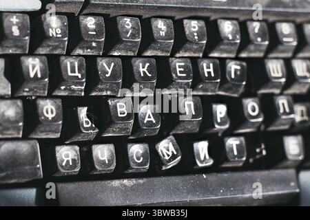 Outdated typewriter close-up. Broken keyboard with Russian letters. Background Stock Photo