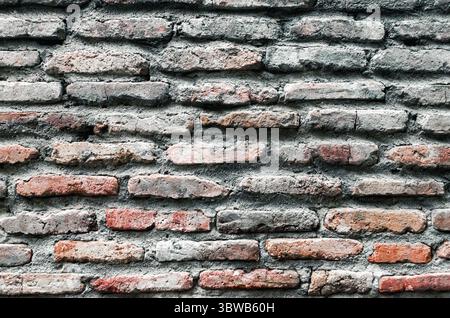 Pattern background of old antique rough vintage brick stone wall close up Stock Photo
