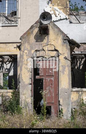 Old broken wooden door of a destroyed house war in Ukraine Stock Photo