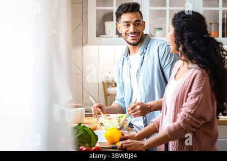 Happy Arab Spouses Preparing Healthy Lunch Together In Kitchen Stock Photo