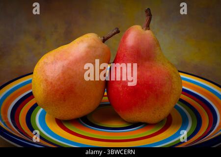 Delicious Pears On Colorful Plate Still life Stock Photo