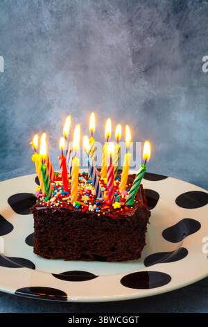 Chocolate Fudge Cake With Candles. Happy Birthday celebration still life Stock Photo
