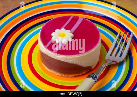 Raspberry Macarpone Cake On Colorful Plate With Fork Still life Stock Photo