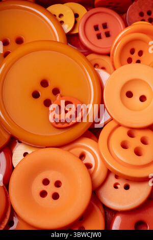 Orange Halloween Button On Pile Of Different Size Orange Buttons Stock Photo