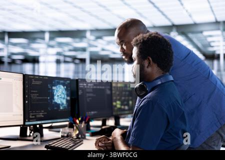 Teamworking server hub coworkers doing AI research, implementing algorithms using neural networks. Team of technicians brainstorming in data center, using artificial intelligence computational models Stock Photo