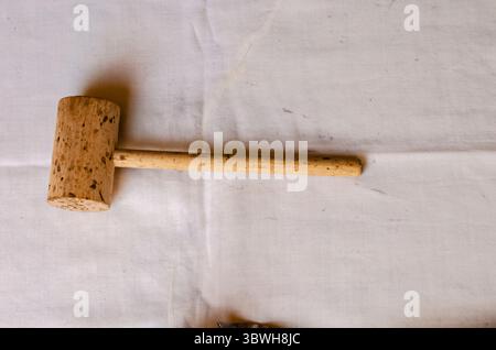 A Meat Mallet On White Fabric Stock Photo