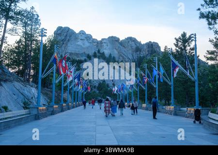 Mount Rushmore and the Avenue of the Americas in South Dakota at dusk, with many tourists visiting the iconic presidential monument and scenic landmar Stock Photo