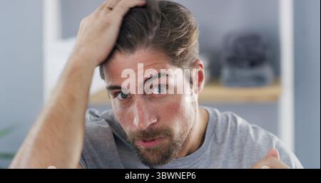 Portrait, man and checking hairline, self care or concerned for hair loss in house, worry and scalp. Home, grooming and inspection for thinning Stock Photo