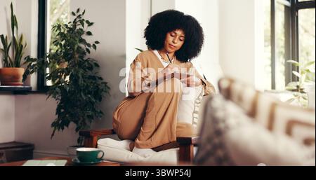 African woman, drawing and tablet at house for editing sketch, design process and graphic designer. Person, remote work and stylus for digital art Stock Photo