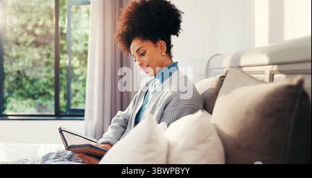 Morning, woman and reading notebook in bedroom for future goal, planning and growth. Relax, writing and female person with journal for gratitude Stock Photo