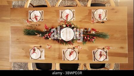 Dining, table decor and christmas with plates for holiday dinner, festive meal or hospitality above. Top view, preparation or getting ready for season Stock Photo