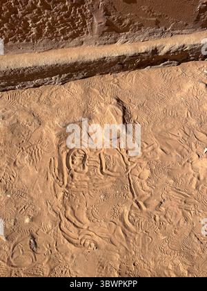 Camel hoof prints and shoe soles in the red sand near Petra, Jordan – detailed texture showing animal tracks and human presence in a desert heritage s Stock Photo
