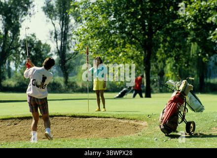 Sport golf player south of france couple playing on green go out bunker Stock Photo
