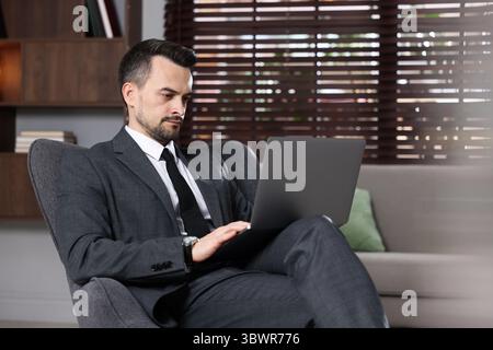 Professional psychologist having online consultation with his client via laptop indoors Stock Photo
