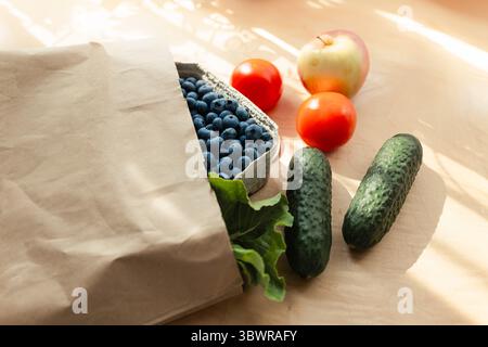 Fruits and vegetables on a kitchen table bought at an organic grocery store. Healthy diet and eating habits. Doing everyday shopping Stock Photo