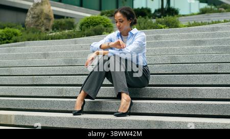 Sad upset stressed tired exhausted thinking problem dismissal work unemployment African American businesswoman woman business girl female entrepreneur Stock Photo