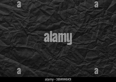 black crumpled paper background, rough page texture Stock Photo