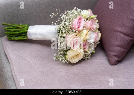 Bridal Bouquet Resting: Close-Up of Wedding Flowers on the Sofa Stock Photo