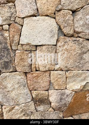 Close-up of irregular granite stones forming an old traditional wall Stock Photo