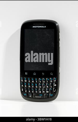 Milan, Lombardy, Italy- February 10, 2025: Old Motorola Fire XT311 mobile phone with blank screen and physical qwerty keyboard isolated on white backg Stock Photo
