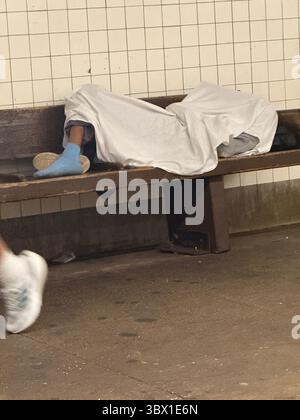 Homeless man sleeps on an E line subway train in New York on Sunday ...