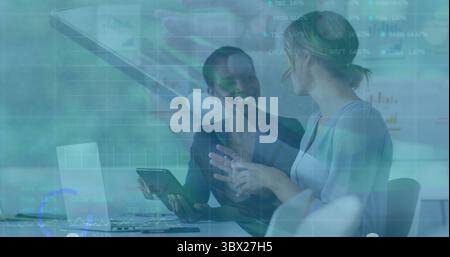 Analyzing metrics two business professionals studying charts at conference table with tablet laptop. Corporate, teamwork, data, analytics, collaborati Stock Photo