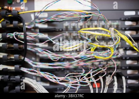 Flat vector is showing multicolored twisted-pair and yellow-sheathed cables through plastic rings. Technology, networking, infrastructure, data, hardw Stock Photo