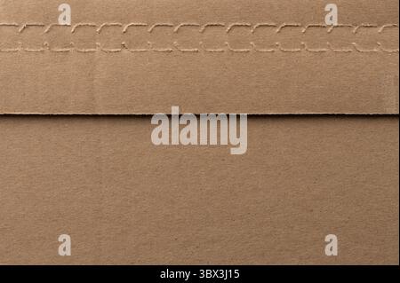 Brown paper envelope with stitched edge rests flat on smooth surface, showcasing its texture and simplicity. Stock Photo
