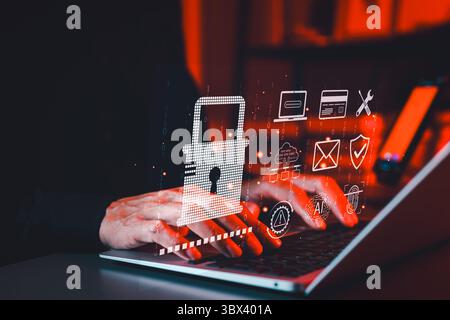 Cybersecurity and Data Protection Technology Concept. Hands typing on a laptop with a padlock icon and security symbols, representing data protection, Stock Photo