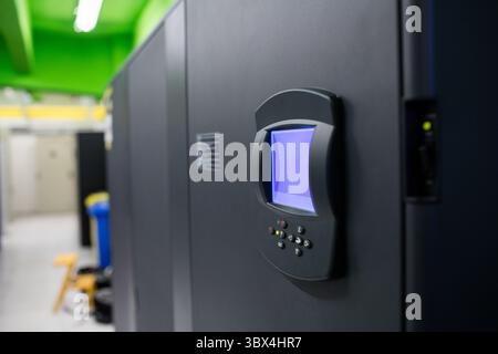 Displaying large black equipment rack in flat design server room, with blue-lit panel and lights. Technology, data center, circuitry, automation, indu Stock Photo