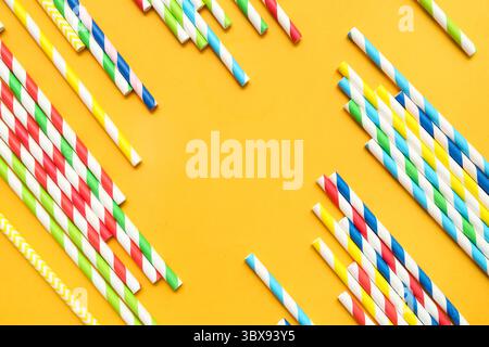 Different paper drinking straws on orange background Stock Photo