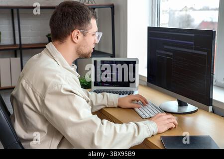 Focused male programmer working in office Stock Photo