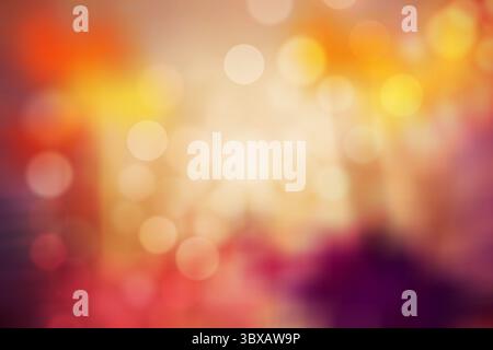 Colorful round bokeh circles pattern is creating soft abstract blur with warm orange and red tones Stock Photo