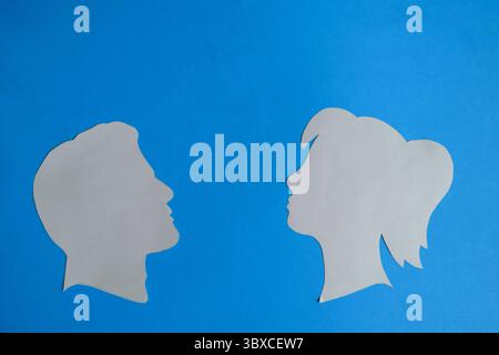 Male and Female Profiles Facing Each Other Stock Photo