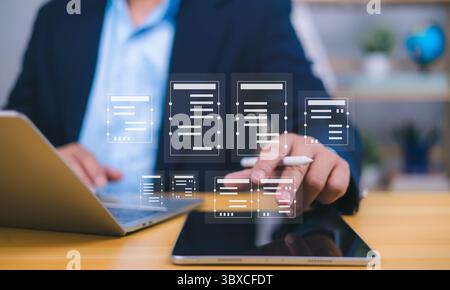 Document management visualized by a person interacting with holographic icons from a tablet, with laptop in background, symbolizing digital workflow, Stock Photo