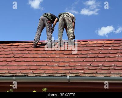 Roofers are working on the roof of a house Stock Photo