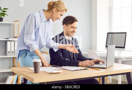 Businesswoman And Businessman Working On Accounting Together Stock Photo
